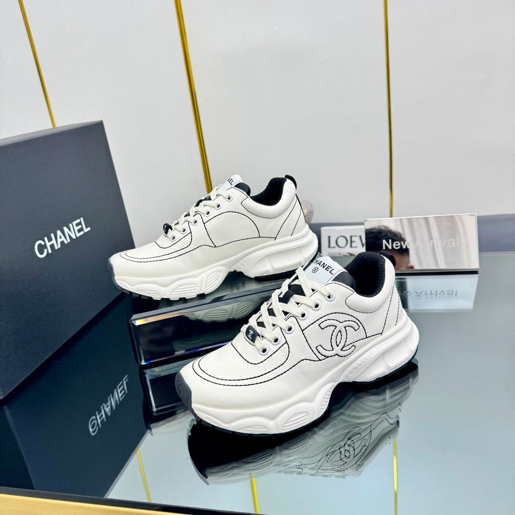 CHANEL TRAINERS SNEAKER IN WHITE CALFSKIN WITH BLACK EMBROIDERED