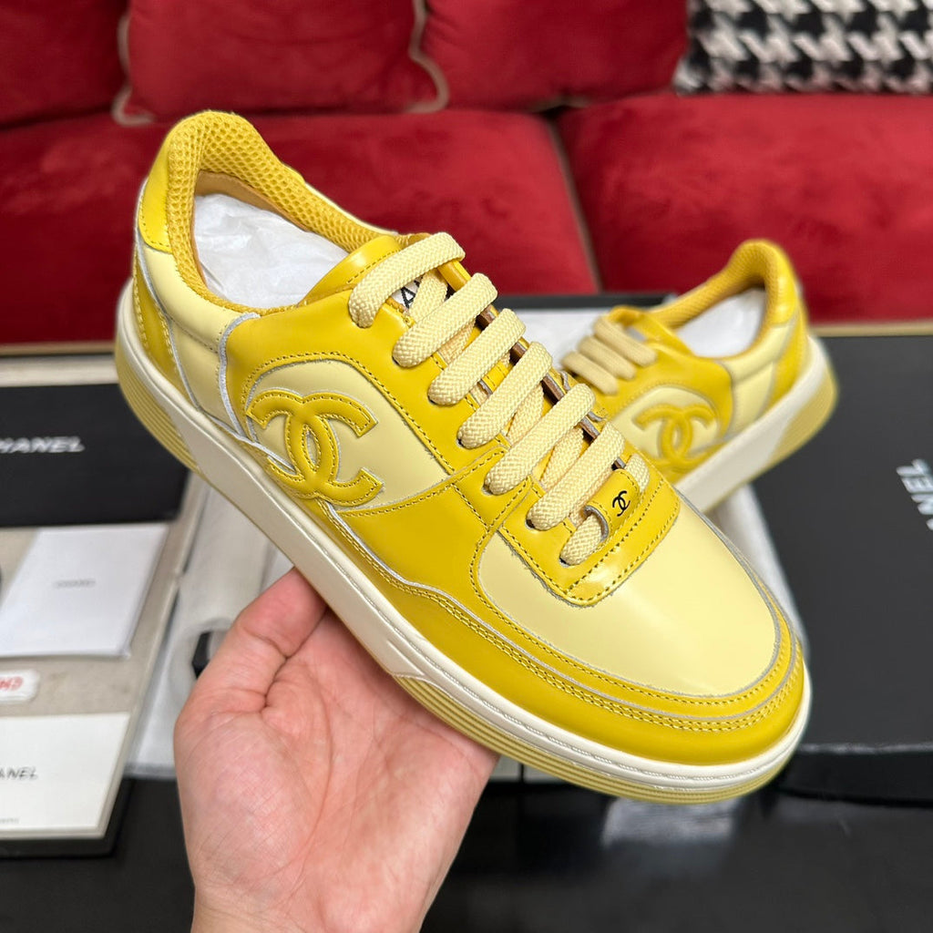 CHANEL TRAINERS IN BRIGHT YELLOW SHINY CALFSKIN