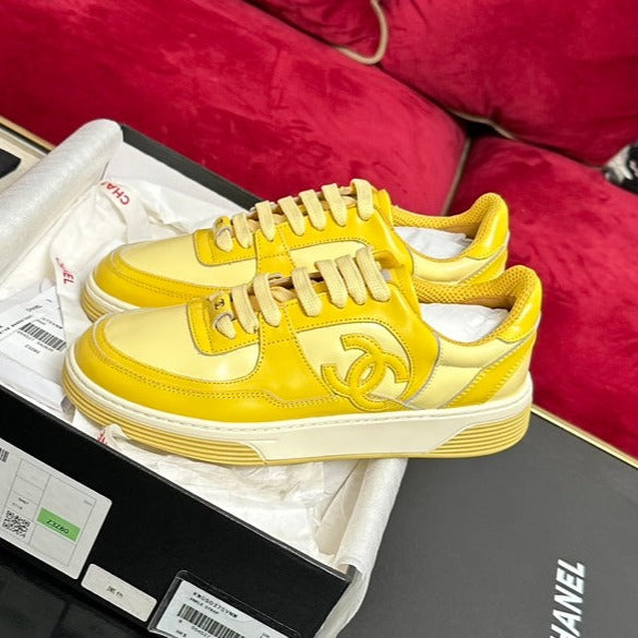 CHANEL TRAINERS IN BRIGHT YELLOW SHINY CALFSKIN
