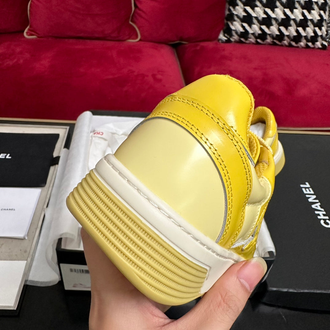 CHANEL TRAINERS IN BRIGHT YELLOW SHINY CALFSKIN