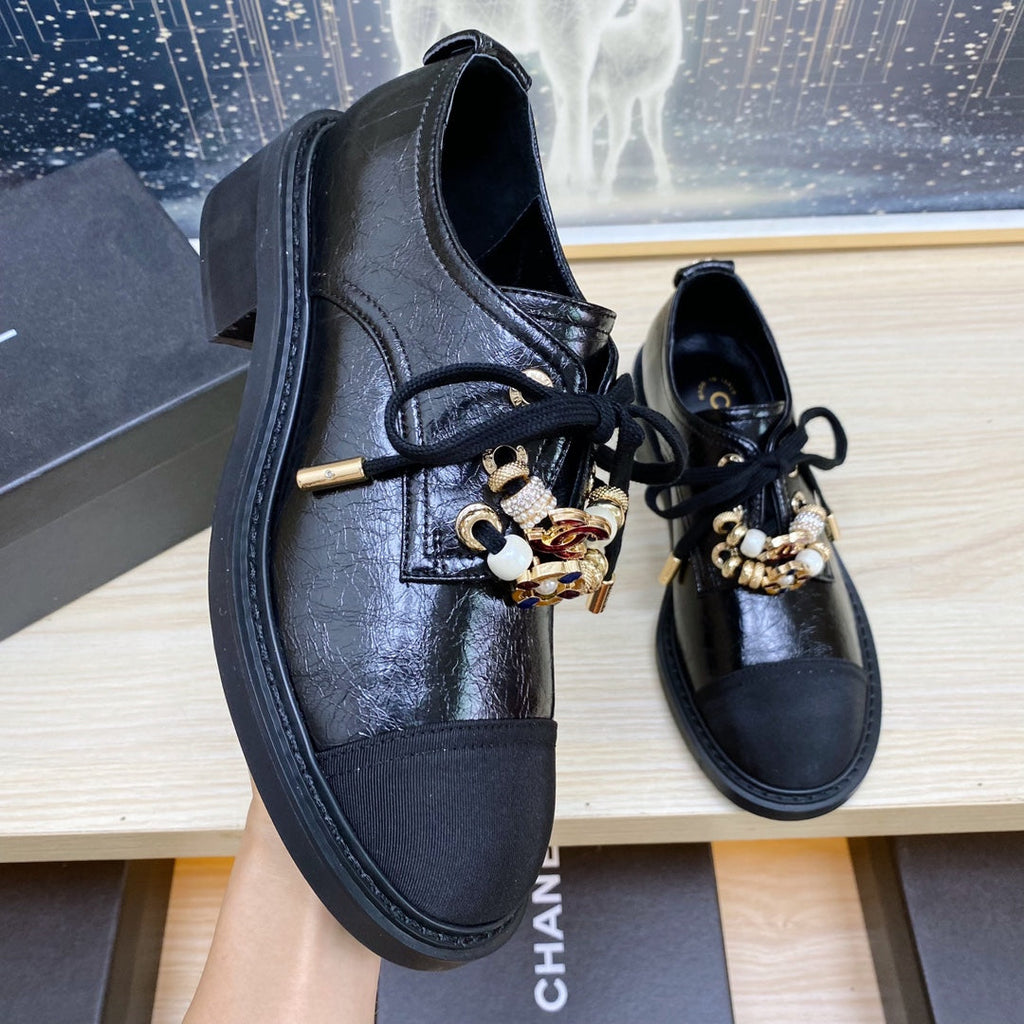 CHANEL COMBAT OXFORD SHOES IN BLACK WRINKLED CALFSKIN AND GROSGRAIN WITH FAUX PEARL