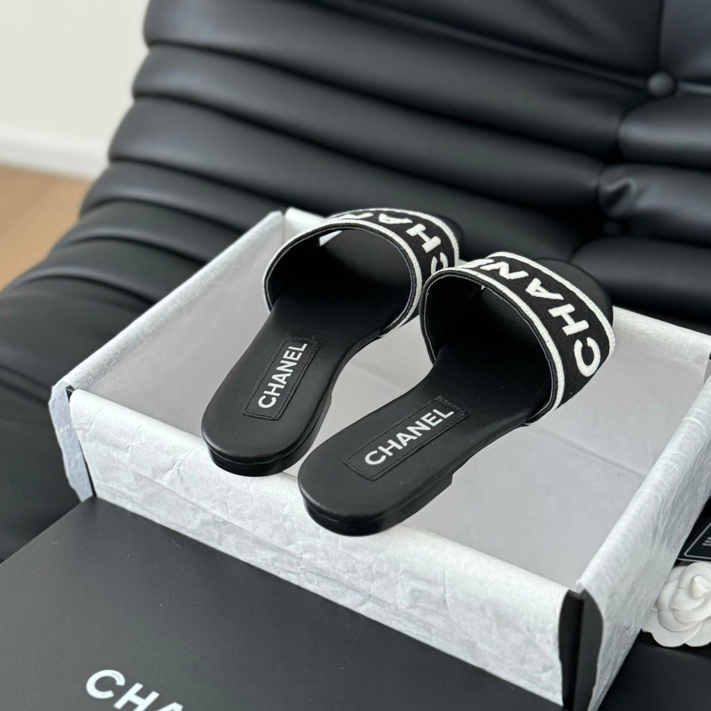 CHANEL Woven Embroidered Letter Slippers Black White