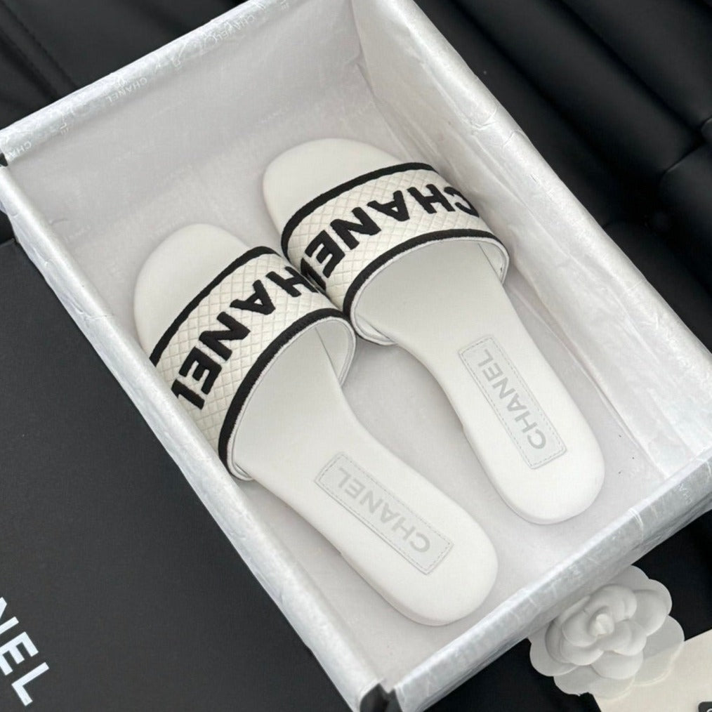 CHANEL Woven Embroidered Letter Slippers White Black