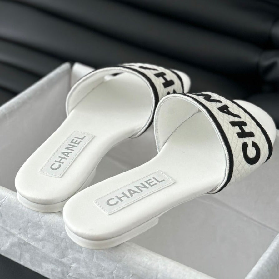CHANEL Woven Embroidered Letter Slippers White Black