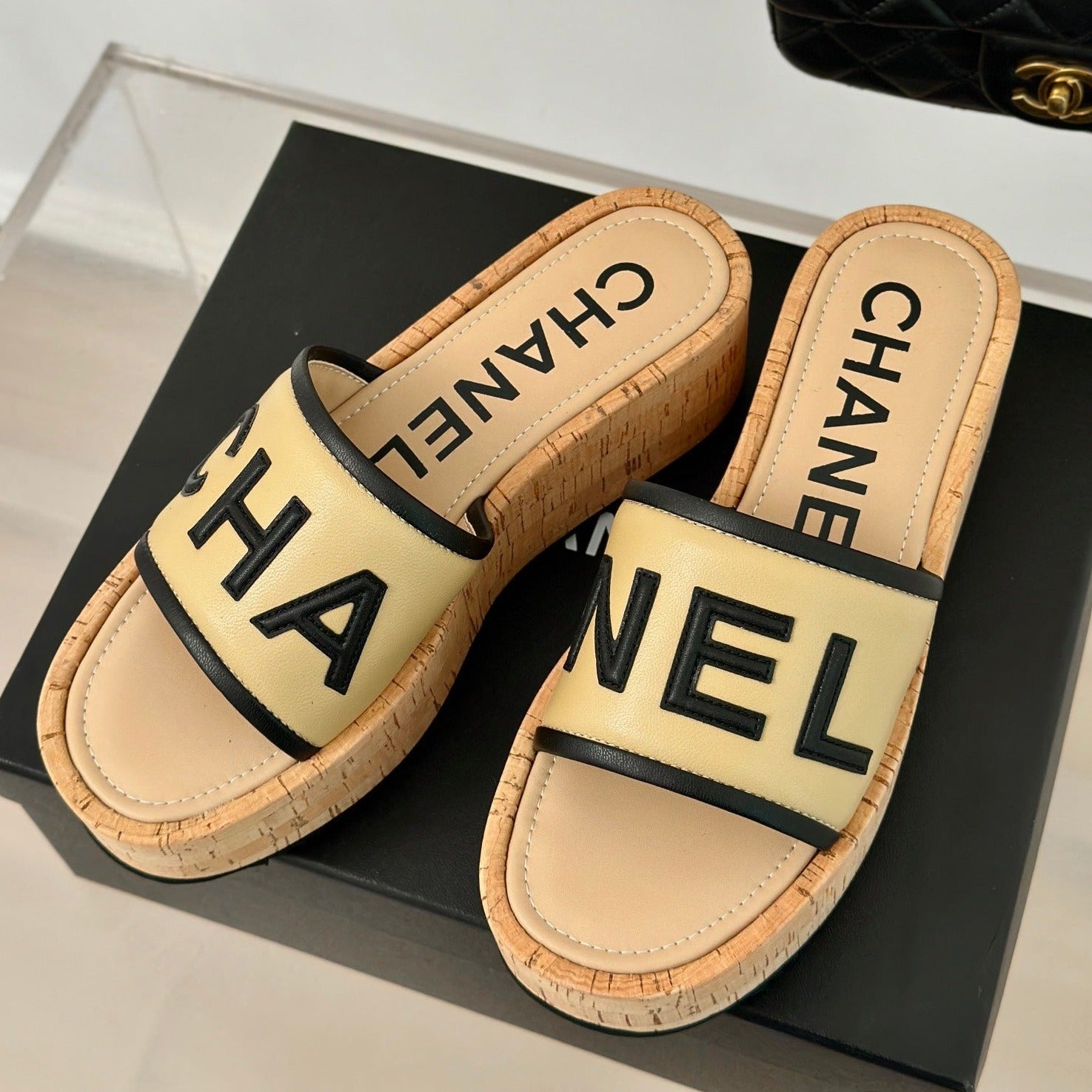 CHANEL THICK SOLE LETTER SLIPPERS IN DARK CREAM SHEEPSKIN