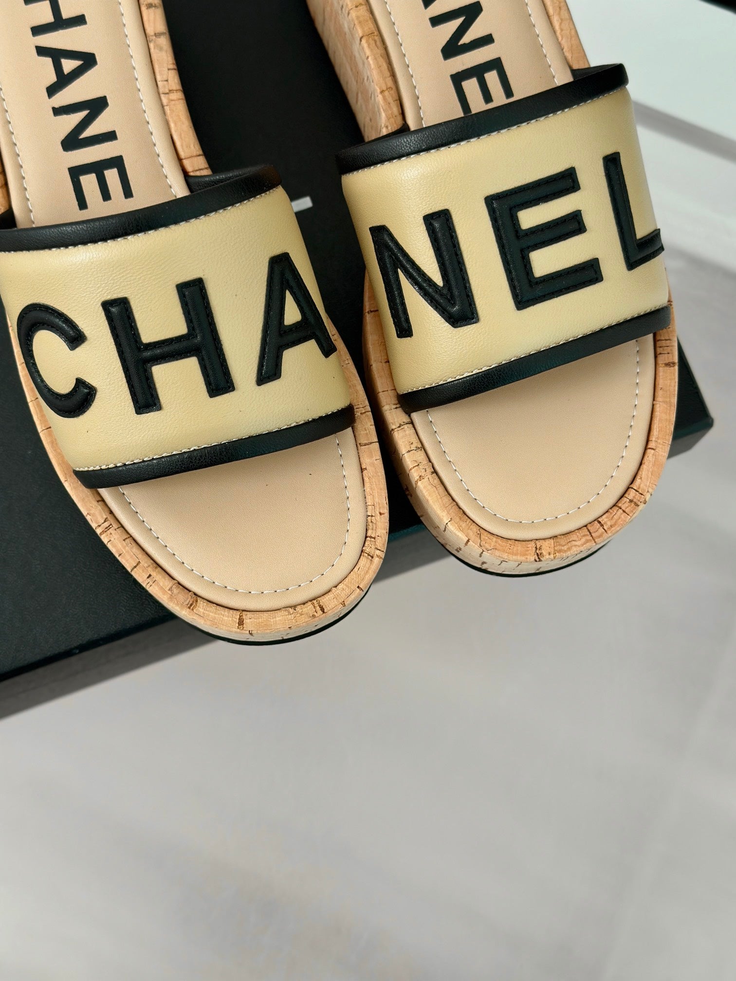 CHANEL THICK SOLE LETTER SLIPPERS IN DARK CREAM SHEEPSKIN