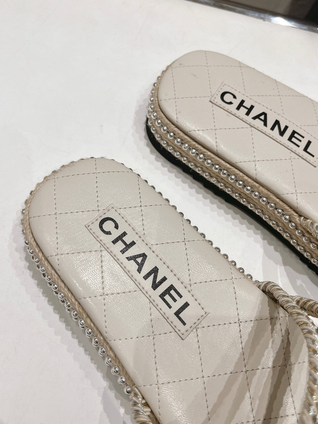 CHANEL WOVEN STRAP SLIPPERS IN WHITE LAMBSKIN