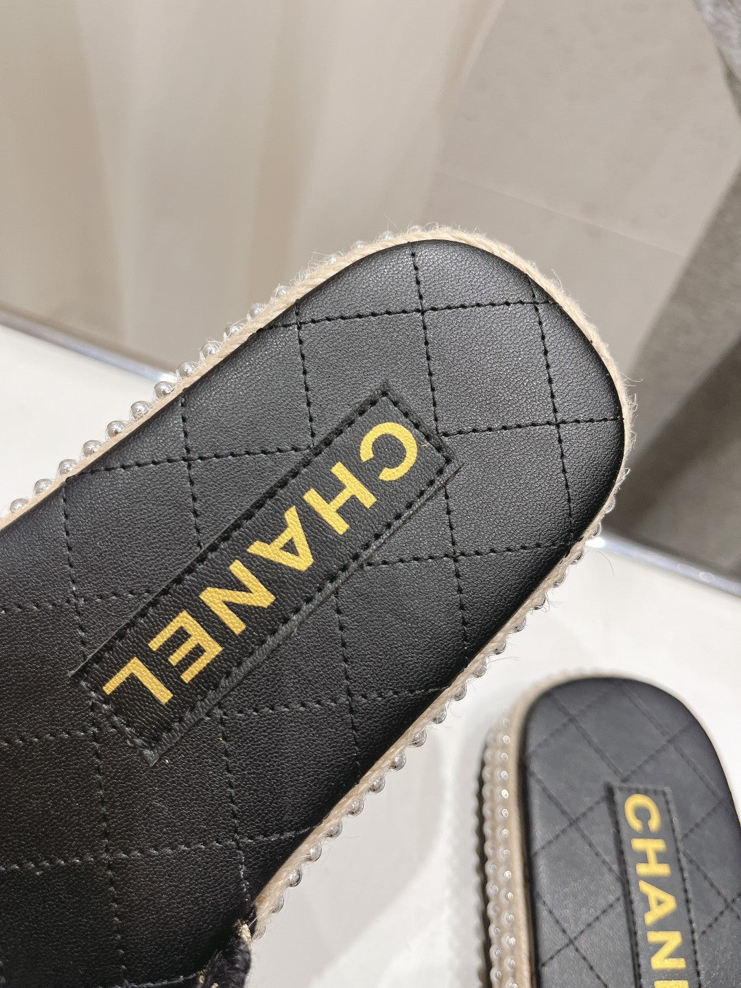 CHANEL WOVEN STRAP SLIPPERS IN BLACK LAMBSKIN