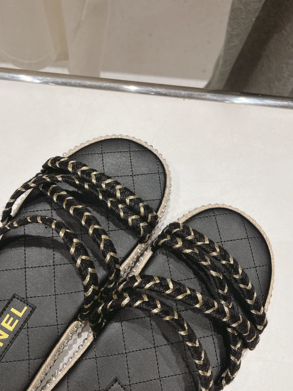 CHANEL WOVEN STRAP SLIPPERS IN BLACK LAMBSKIN